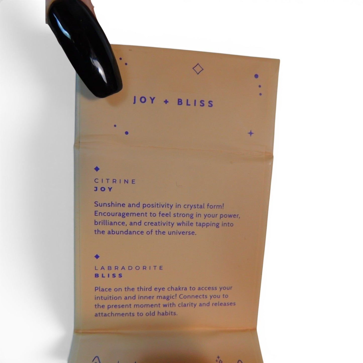 The Witches' Quest Joy + Bliss collection card detailing Citrine and Labradorite crystal properties and meanings.