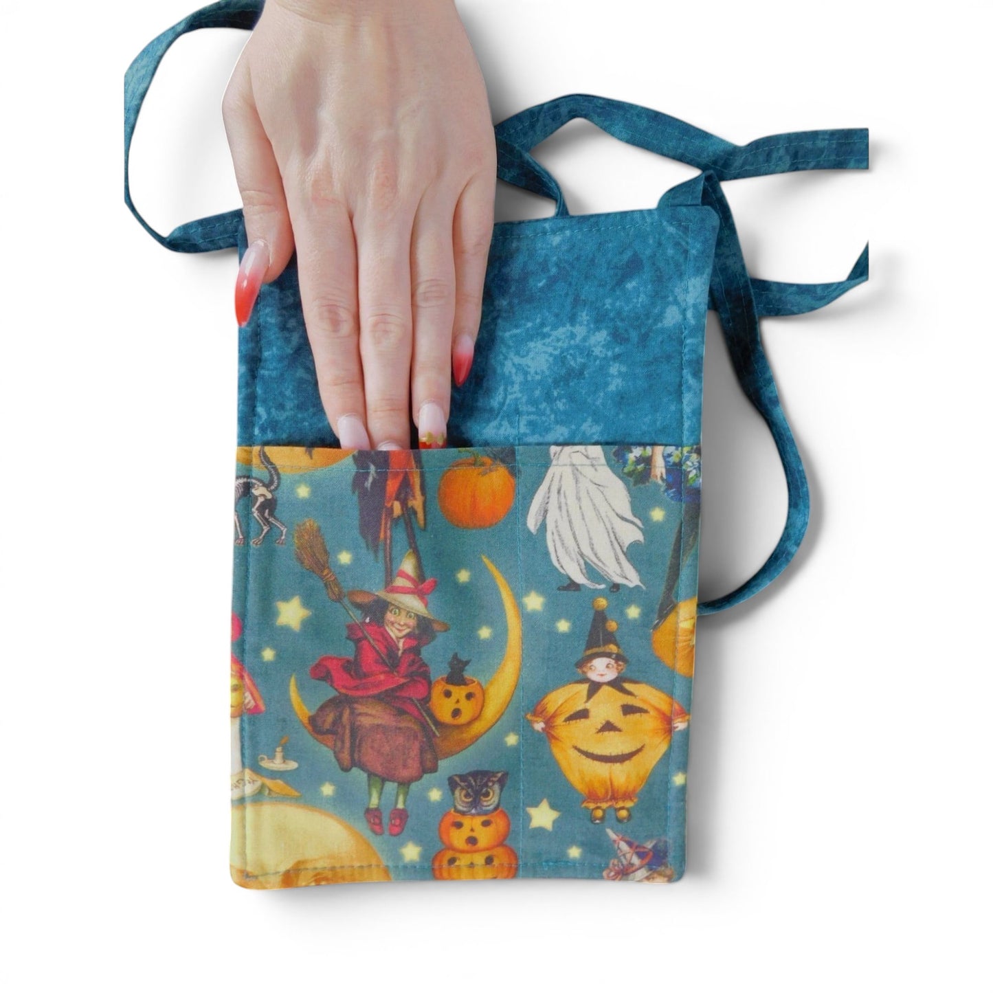 The Witches' Quest handmade Halloween crossbody bag with vintage witch and pumpkin print on a wooden autumn background