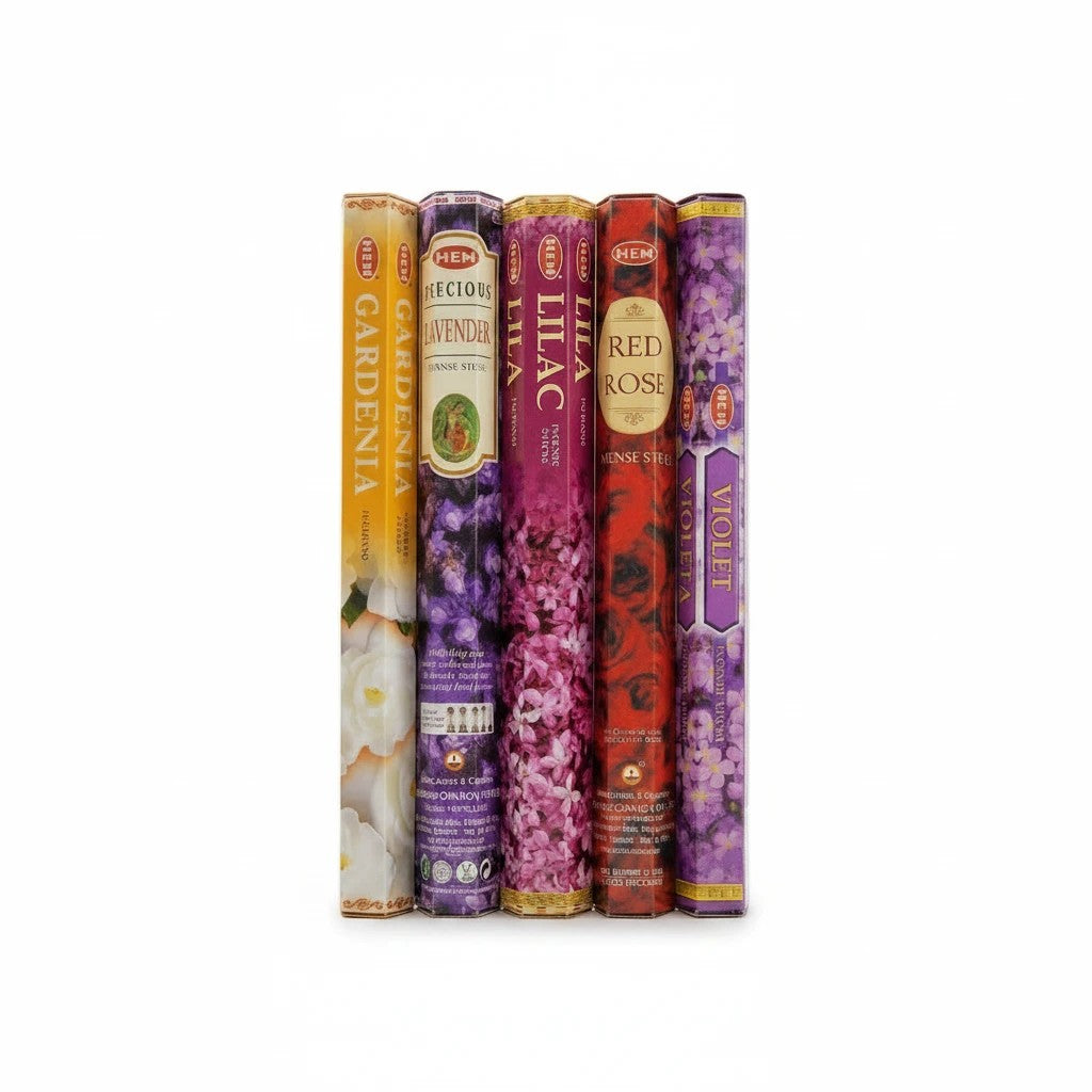 The Witches' Quest HEM floral incense variety pack featuring five hexagonal boxes of gardenia, lavender, lilac, rose, and violet scents.