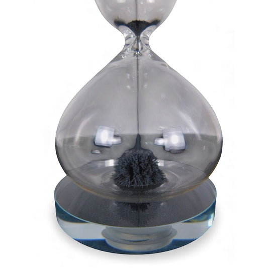The Witches' Quest magnetic hourglass with black iron filings forming a stalagmite shape inside clear glass.