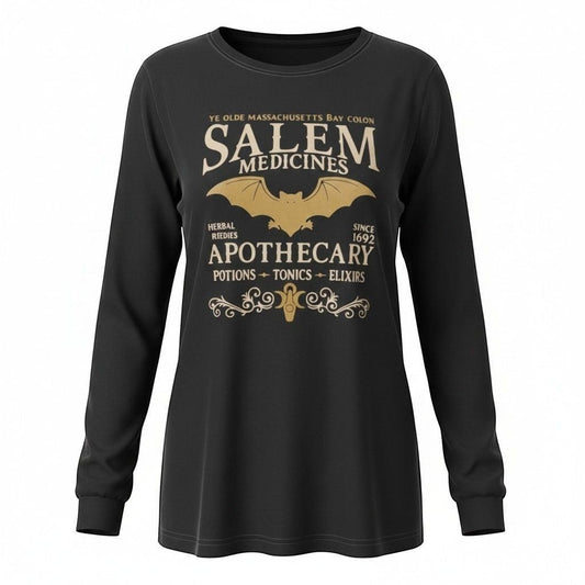 The Witches' Quest black long sleeve crewneck shirt featuring a gold Salem Apothecary graphic with a bat and scrollwork.