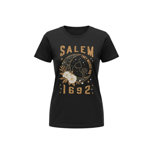 The Witches' Quest black cotton unisex t-shirt featuring a Salem 1692 graphic with a cat, moon, and floral design.