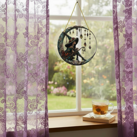 The Witches' Quest witch sitting on a crescent moon wall ornament with dangling jewels hanging in a window.