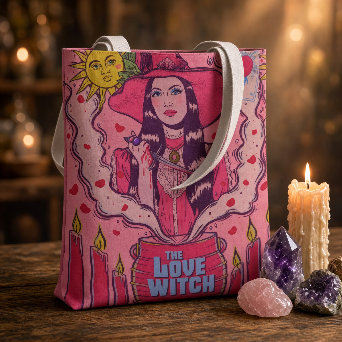 Love Witch tote bag with illustration of a woman in a pink hat holding a dagger over a cauldron