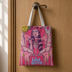 Love Witch tote bag featuring a witch illustration with a cauldron and candles hanging on a wooden door