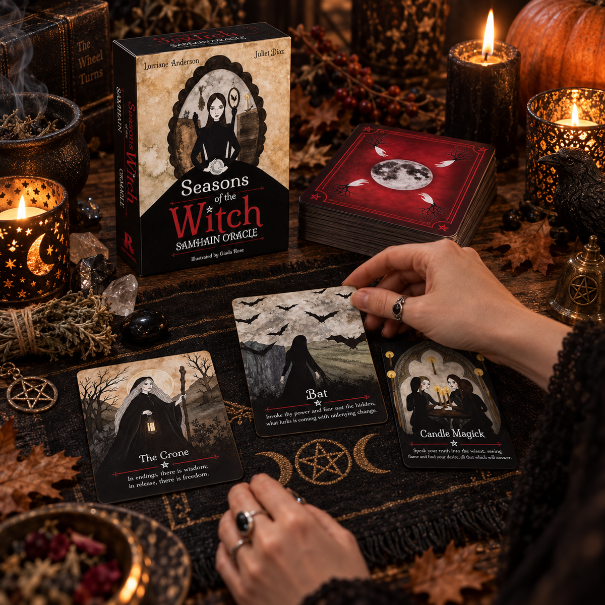 Seasons of the Witch Samhain Oracle deck and guidebook with cards laid out on a table with candles and ritual items
