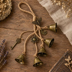 Brass-tone witch bells with sun moon key and moth charms hanging on jute rope