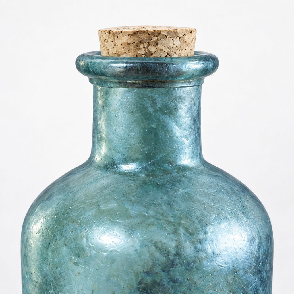Close up of a blue textured glass apothecary bottle with a cork stopper