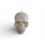White skull shaped candle with a glittered finish