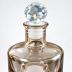 Crystal Stopper Ritual Bottle with faceted clear glass sphere topper on a tinted glass bottle
