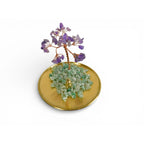 The Witches' Quest amethyst gemstone tree ornament with green aventurine chips on a polished gold-toned metal tray.