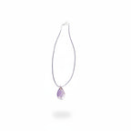 The Witches' Quest amethyst teardrop pendant necklace with a wire-wrapped tree of life design on a purple cord.