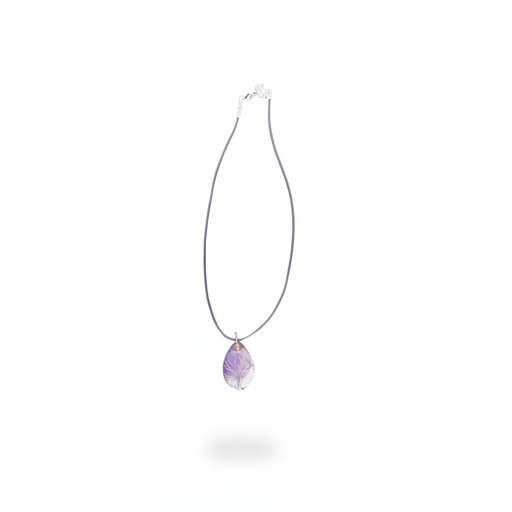 The Witches' Quest amethyst teardrop pendant necklace with a wire-wrapped tree of life design on a purple cord.