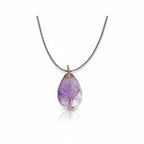 The Witches' Quest amethyst teardrop pendant necklace with a copper wire wrapped Tree of Life design on a black cord.