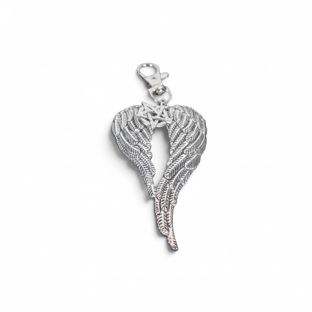 The Witches' Quest silver-toned keychain featuring detailed angel wings cradling a pentagram with a secure metal clip.