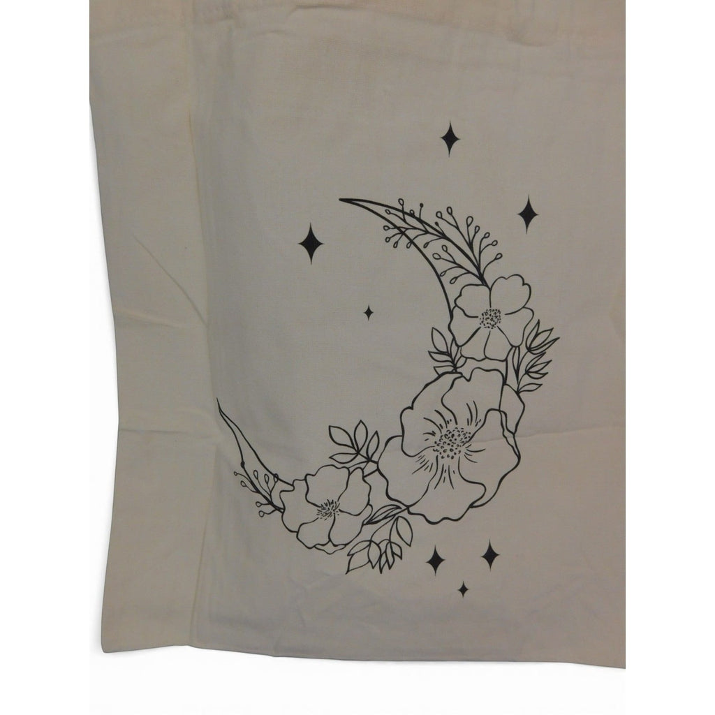 The Witches' Quest beige canvas tote bag featuring a black line art crescent moon with floral and star details.