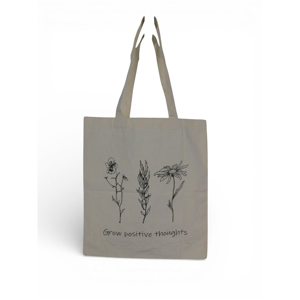 The Witches' Quest large beige canvas tote bag with black floral line art and Grow positive thoughts quote