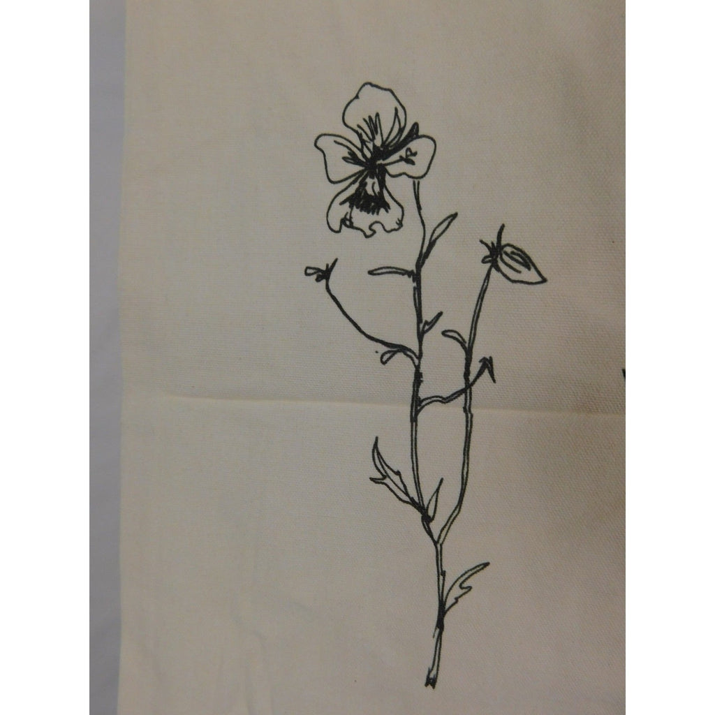 The Witches' Quest beige canvas tote bag featuring a black line art floral illustration on the front