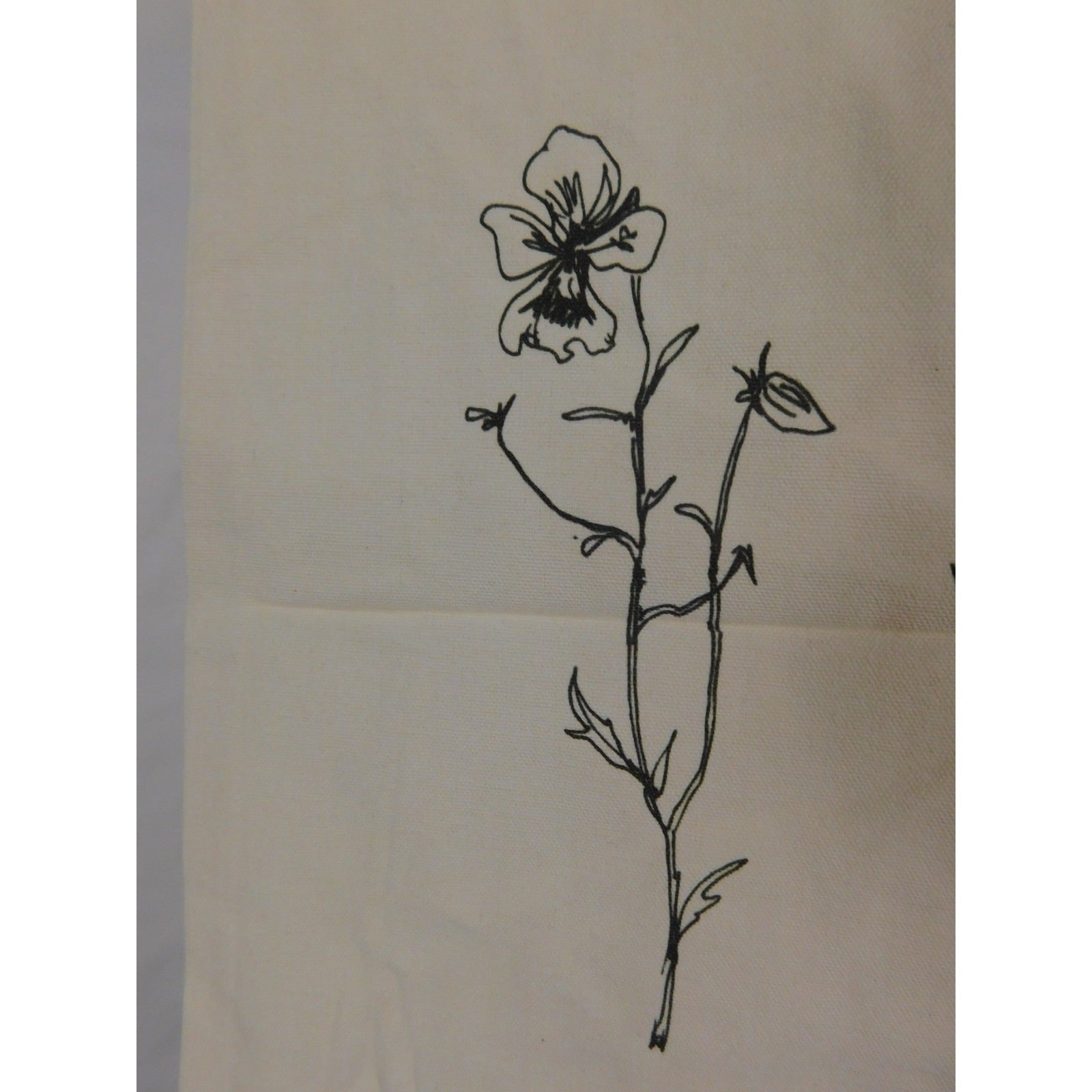The Witches' Quest beige canvas tote bag featuring a black line art floral illustration on the front