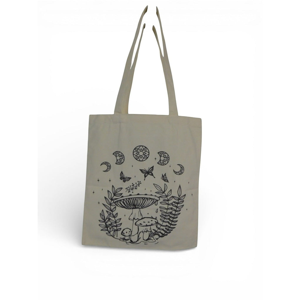 The Witches' Quest beige canvas tote bag featuring black line-art illustrations of mushrooms, butterflies, and moons.