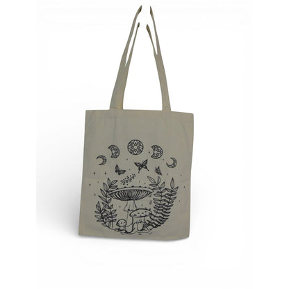 The Witches' Quest beige canvas tote bag featuring black line-art illustrations of mushrooms, butterflies, and moons.