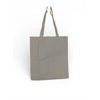 The Witches' Quest large beige canvas tote bag with long shoulder straps, shown from the plain back side.