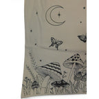 The Witches' Quest beige canvas tote bag featuring black line-art of mushrooms, butterflies, and a crescent moon.