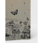 The Witches' Quest beige canvas tote bag featuring black line-art of mushrooms, butterflies, and celestial motifs.