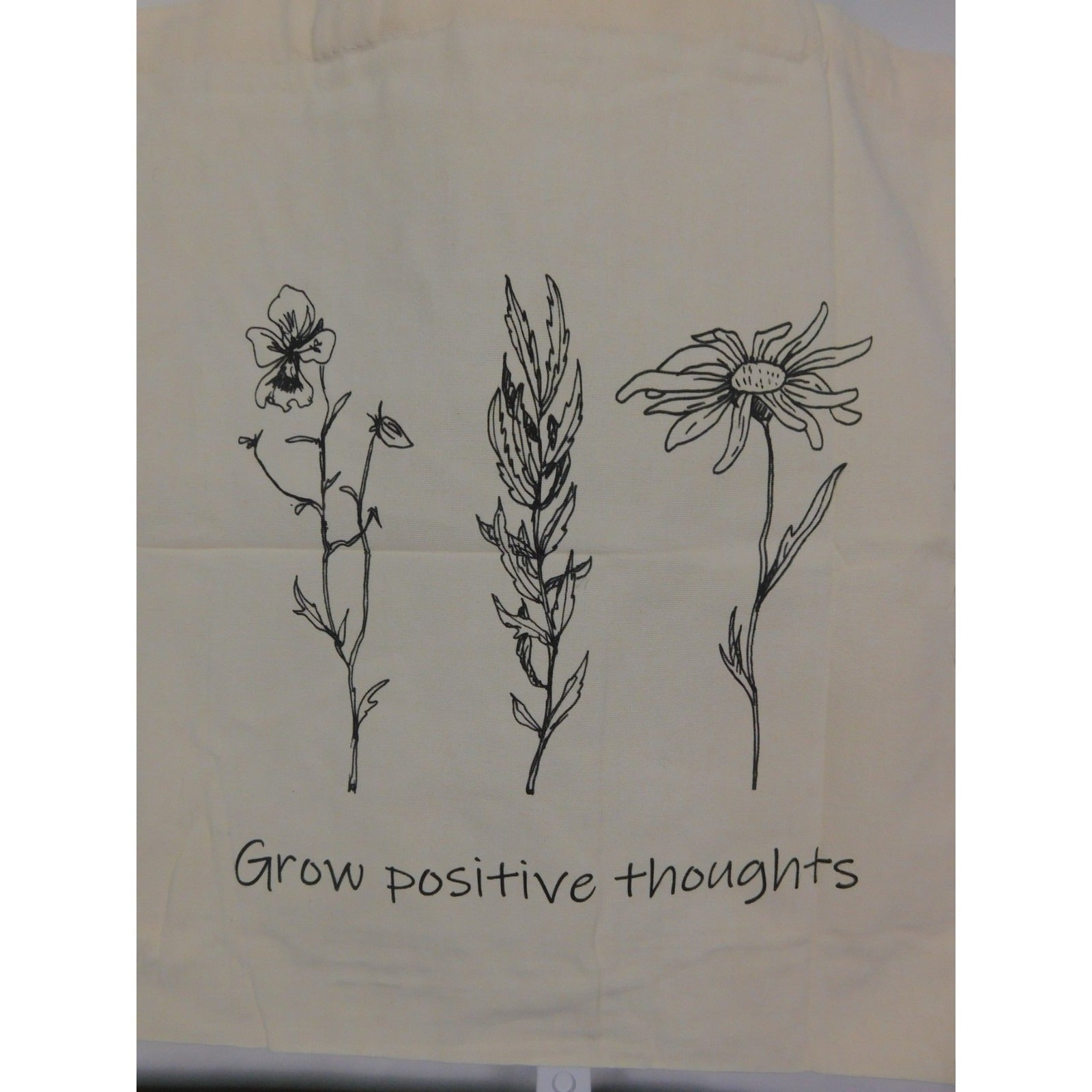 The Witches' Quest large beige canvas tote bag with black floral line art and Grow positive thoughts text