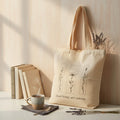 The Witches' Quest beige canvas tote bag featuring floral line art and the quote Good things are coming