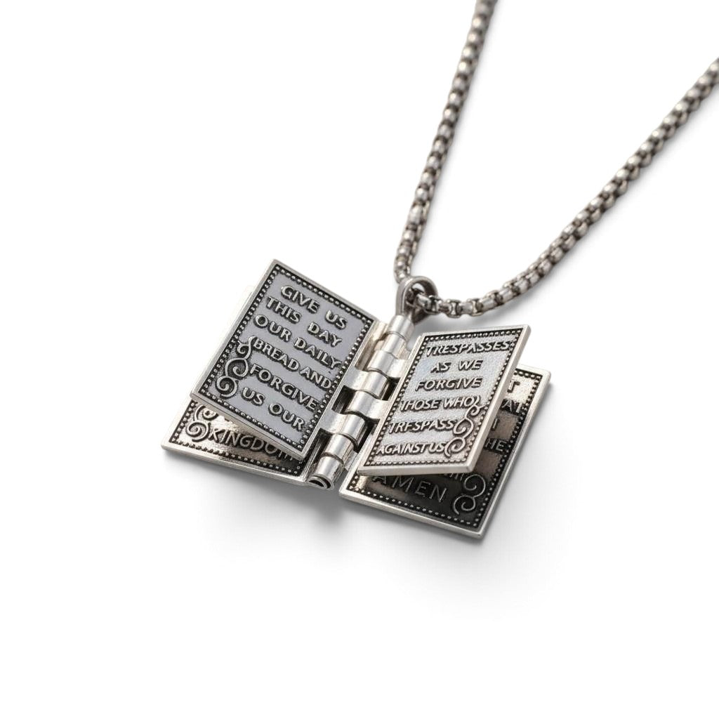 The Witches' Quest silver tone rectangular Bible locket necklace with engraved Lord's Prayer text on open pages.