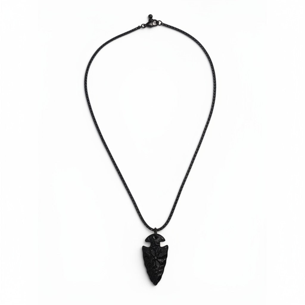 The Witches' Quest black arrowhead pendant necklace with engraved compass symbol on a textured chain