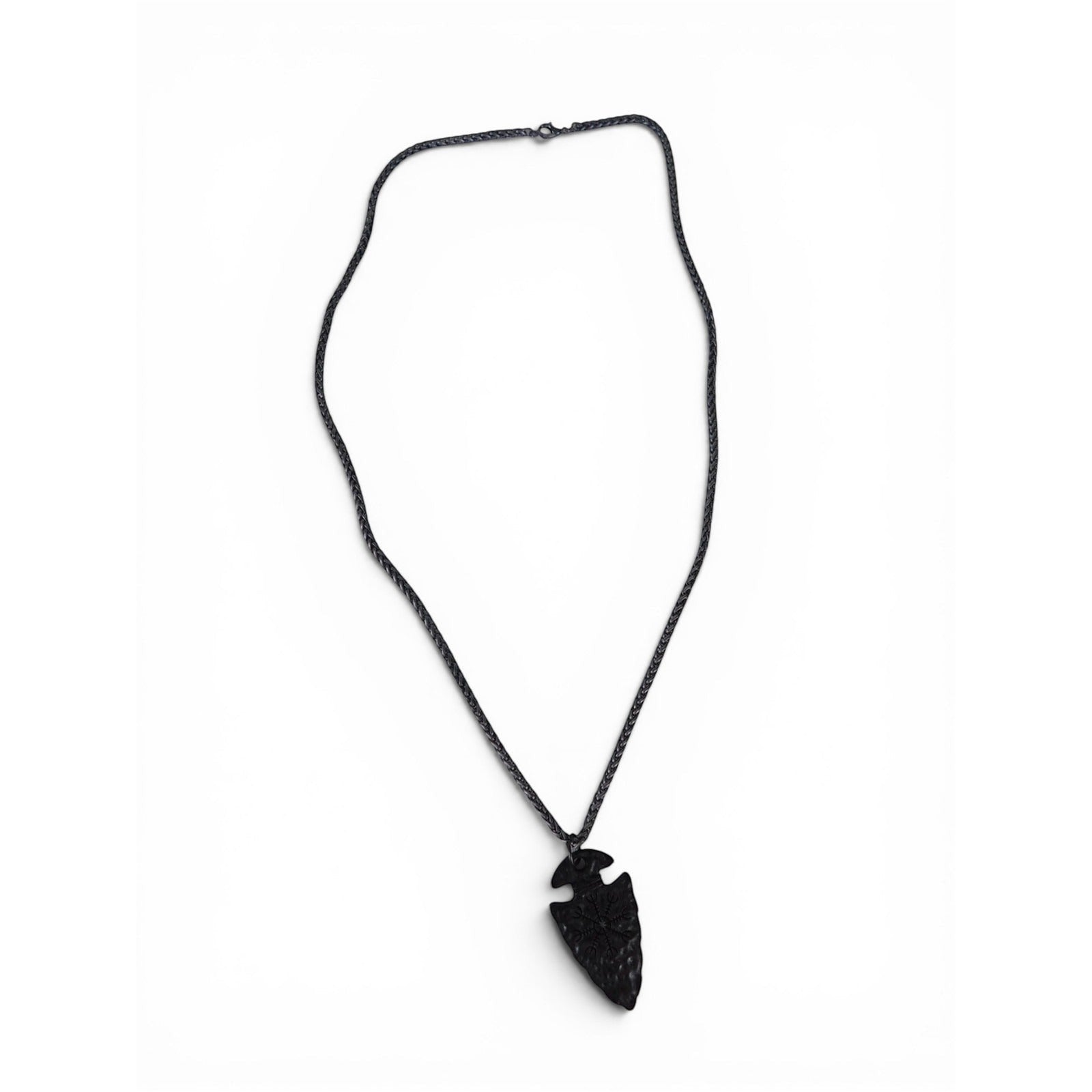 The Witches' Quest black arrowhead pendant necklace with engraved Viking compass symbol on a textured chain.