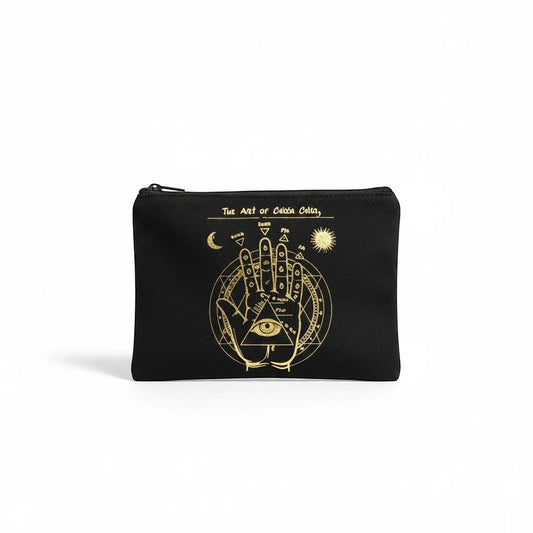 The Witches' Quest black canvas zipper pouch featuring a gold mystical chiromancy hand design on a white background.