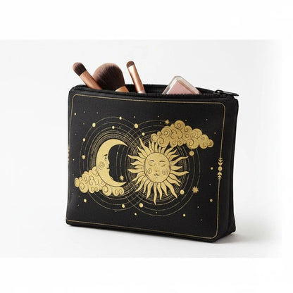 The Witches' Quest black canvas zippered pouch with gold celestial sun and moon print, holding makeup brushes.