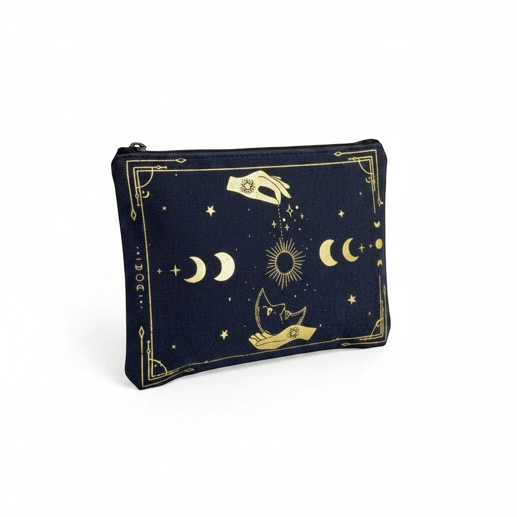 The Witches' Quest black canvas clutch with gold celestial moon, sun, and star print, featuring a top zip closure.