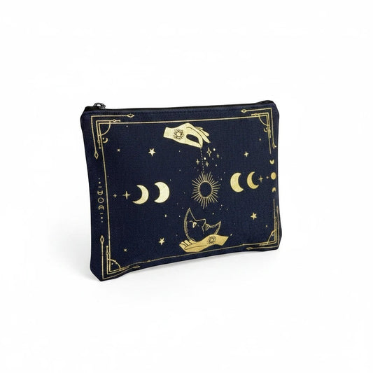The Witches' Quest black canvas clutch with gold celestial moon, sun, and star print, featuring a top zip closure.