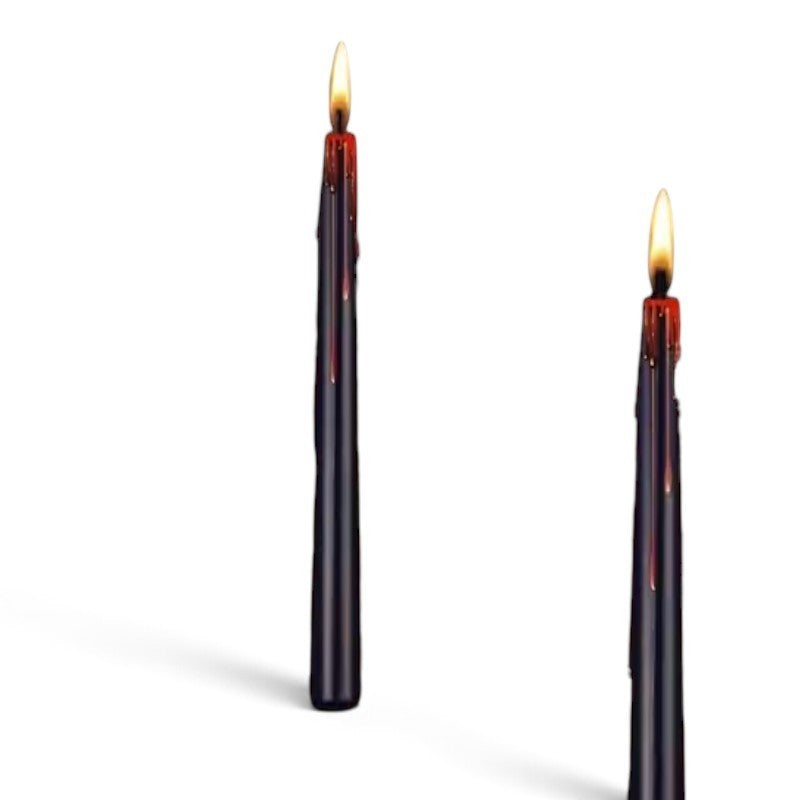The Witches' Quest ritual candles in black with a dramatic dripping effect and a warm flame, set of two.