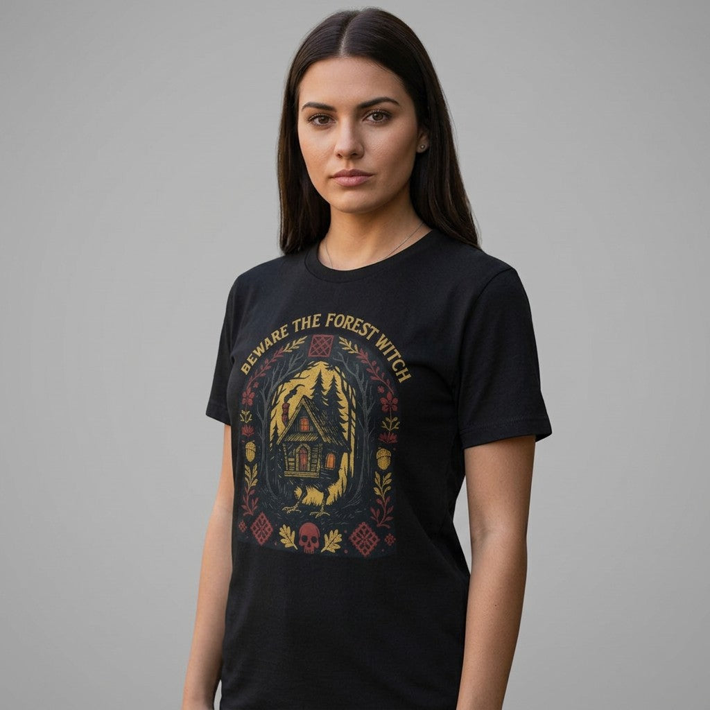 The Witches' Quest black unisex cotton t-shirt featuring a Beware The Forest Witch cottage and forest graphic print.