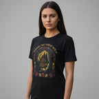 The Witches' Quest black unisex cotton t-shirt featuring a Beware The Forest Witch cottage and forest graphic print.