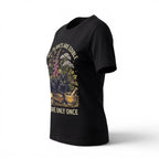 The Witches' Quest black cotton t-shirt featuring a botanical cat graphic with the text All Plants Are Edible