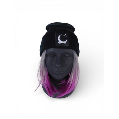 The Witches' Quest black ribbed knit beanie with a crescent moon and stars patch and satin lining on a mannequin head