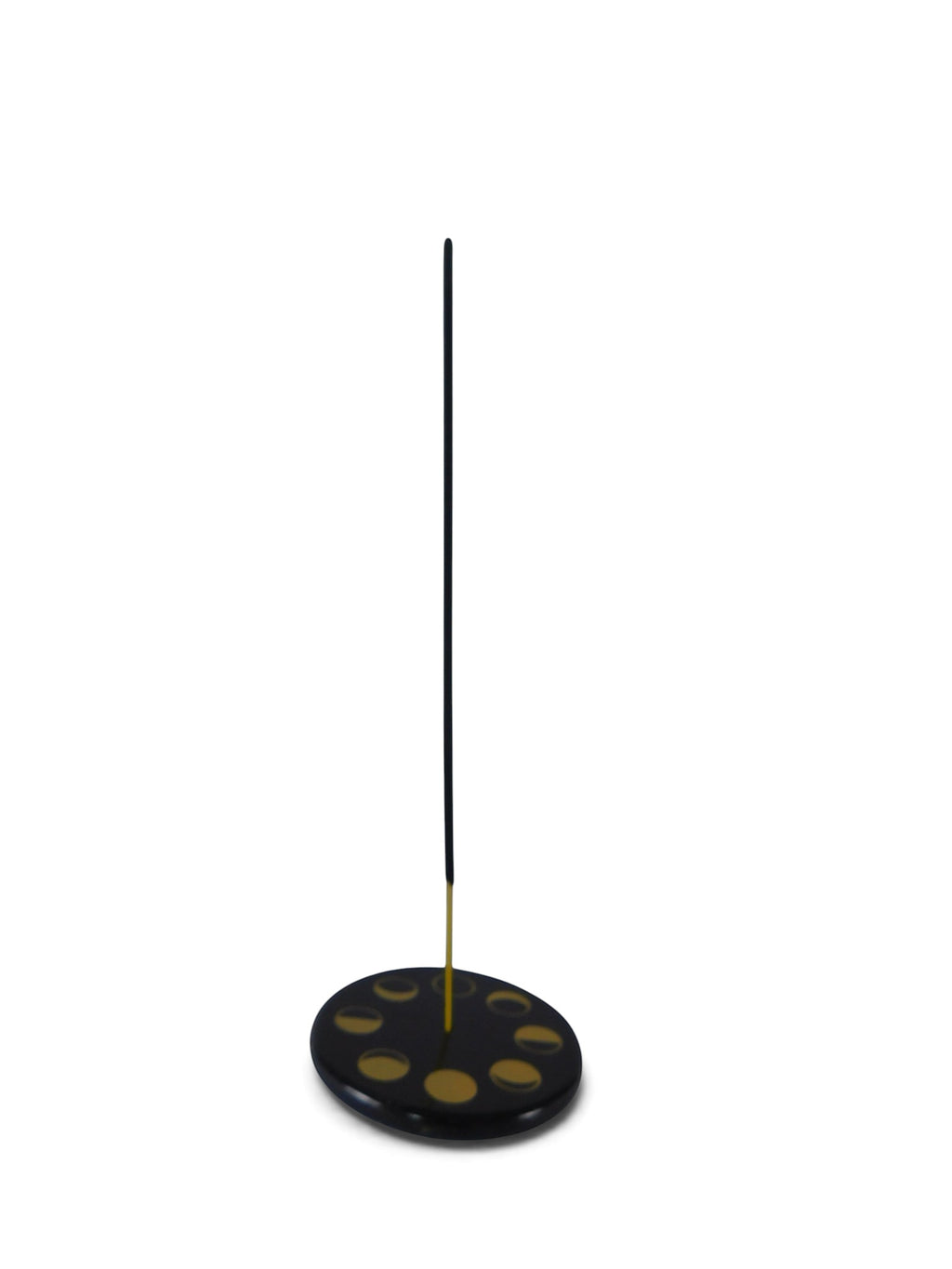 The Witches' Quest black stone ceramic incense holder with gold celestial moon phase design and a burning incense stick