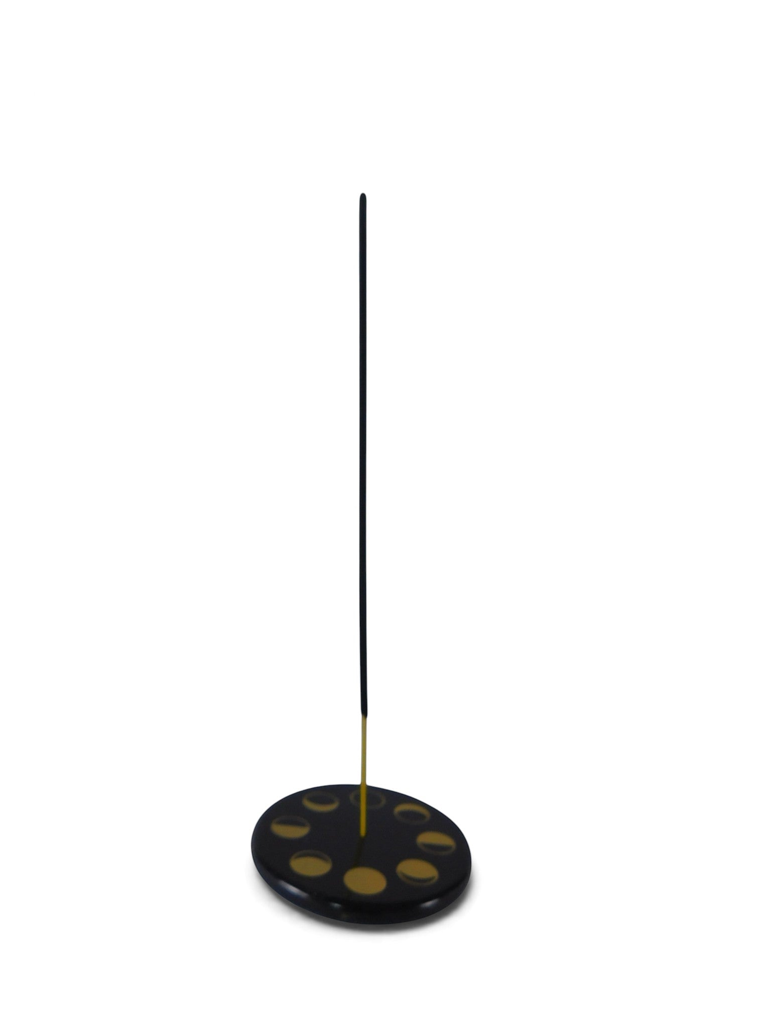 The Witches' Quest black stone ceramic incense holder with gold celestial moon phase design and a burning incense stick