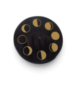 The Witches' Quest black stone ceramic incense holder with gold celestial moon phase design and central stick hole