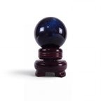The Witches' Quest polished black obsidian sphere for scrying and meditation, displayed on a dark wooden stand.