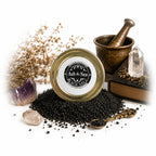 The Witches' Quest witch-forged black salt in a glass jar with crystals, mortar, and pestle for ritual protection.