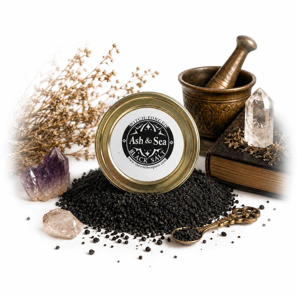 The Witches' Quest witch-forged black salt in a glass jar with crystals, mortar, and pestle for ritual protection.
