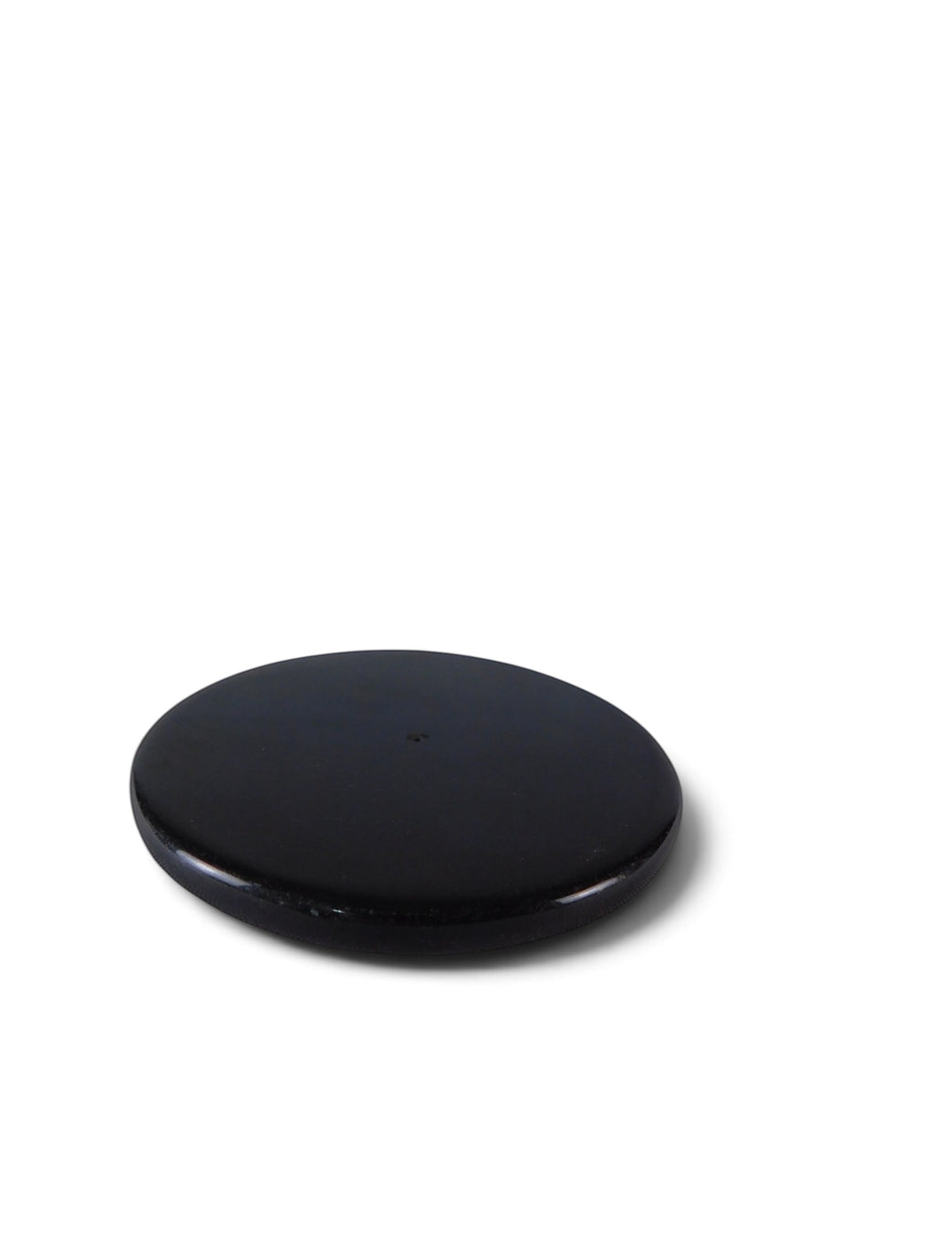The Witches' Quest black polished stone round incense holder plate with a central hole for incense sticks.