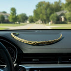 The Witches' Quest braided sweetgrass smudge stick resting on a car dashboard for cleansing and protection.